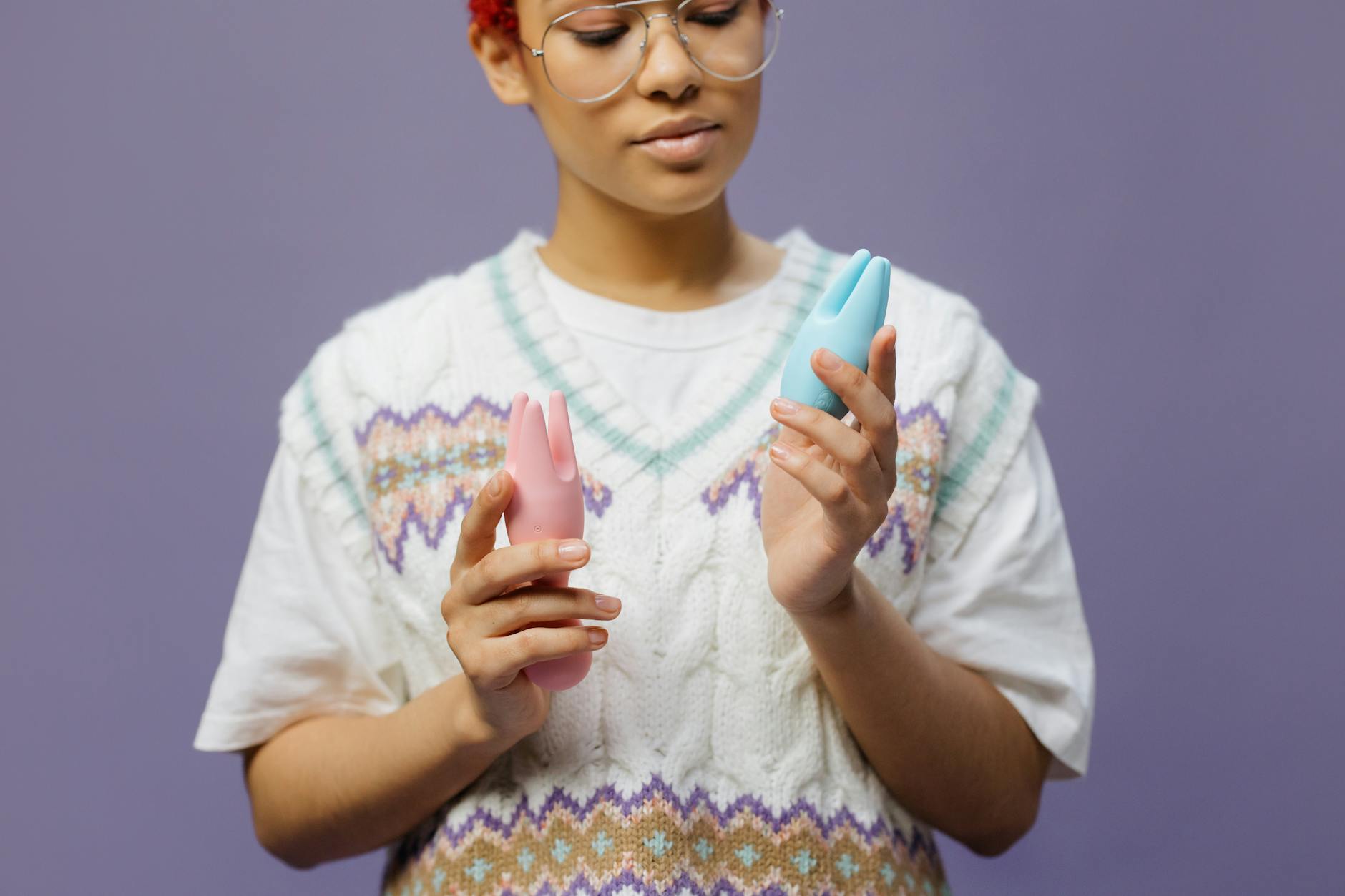 Woman holding a silicone vibrator, contemplative and confident