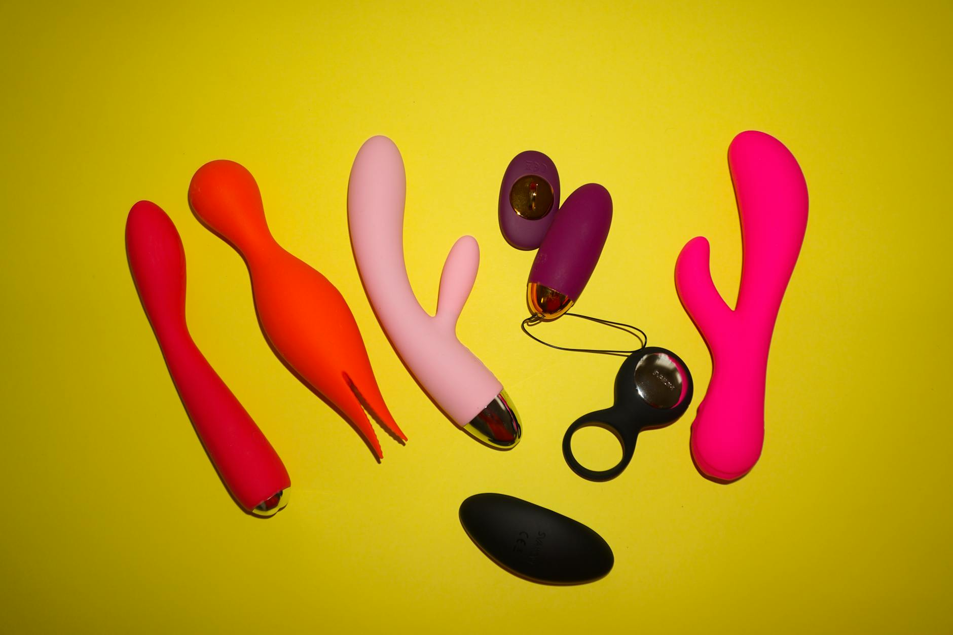 Hand holding a modern clitoral vibrator against a soft purple background, symbolizing self-care and intimate reconnection.